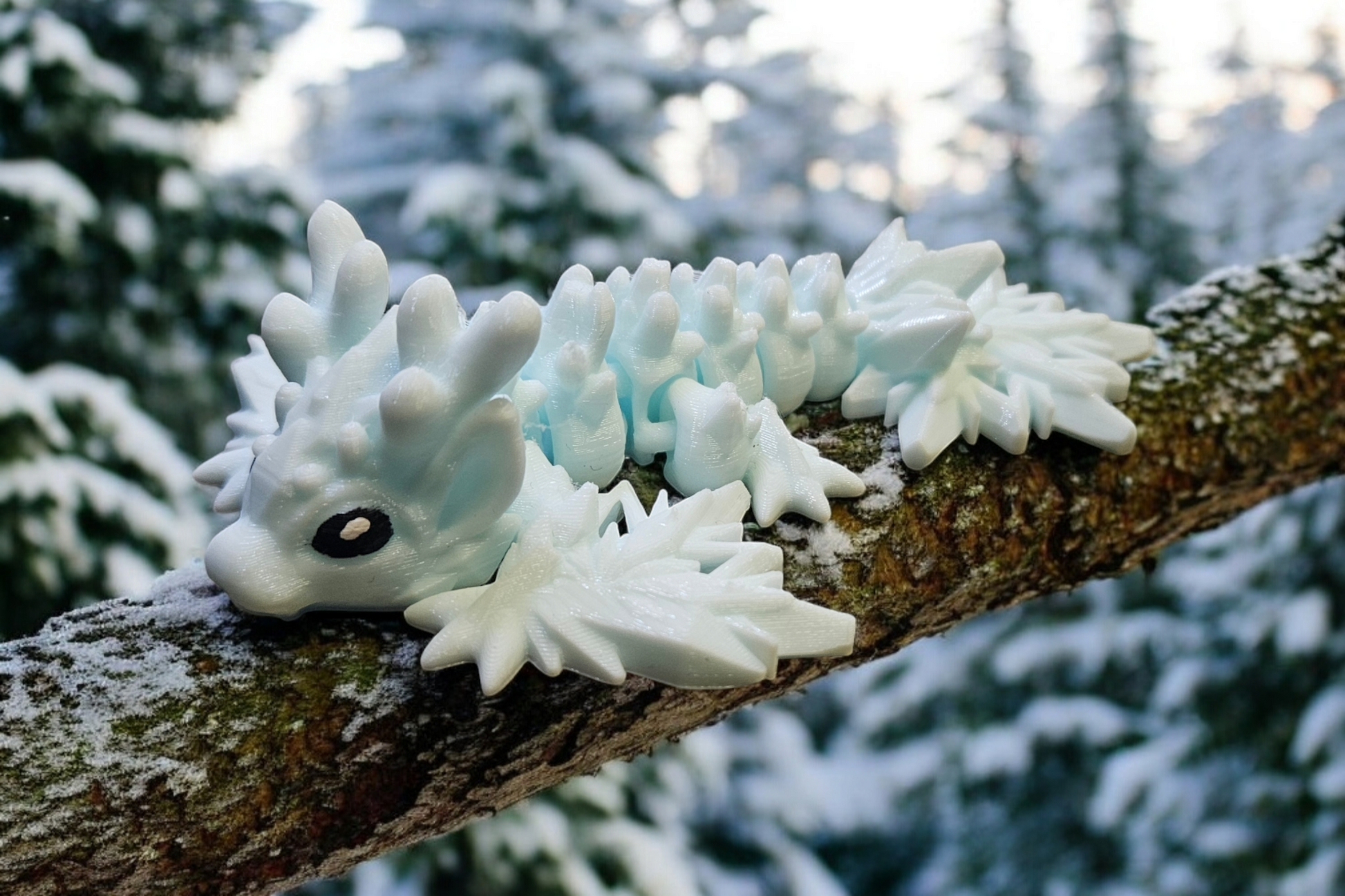 Tiny Winter Dragon on a snow covered branch